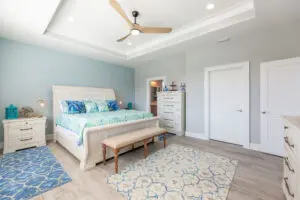 Bright, airy bedroom with blue accents and modern furniture.