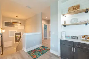 Bright hallway with modern decor and colorful rug.